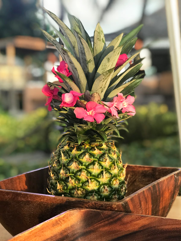 Pineapple with flowers as decor at Sandals Resorts Wedding. 