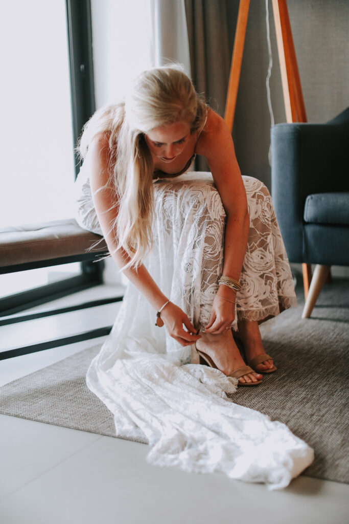 bride getting ready with lace dress