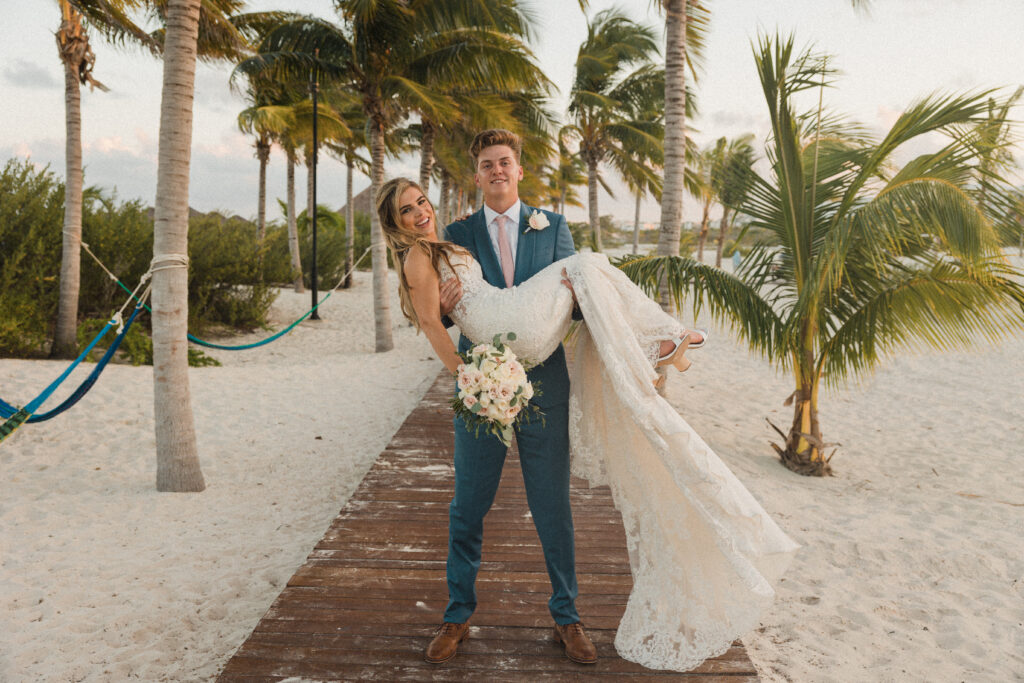 bride and groom on a beach boardwalk