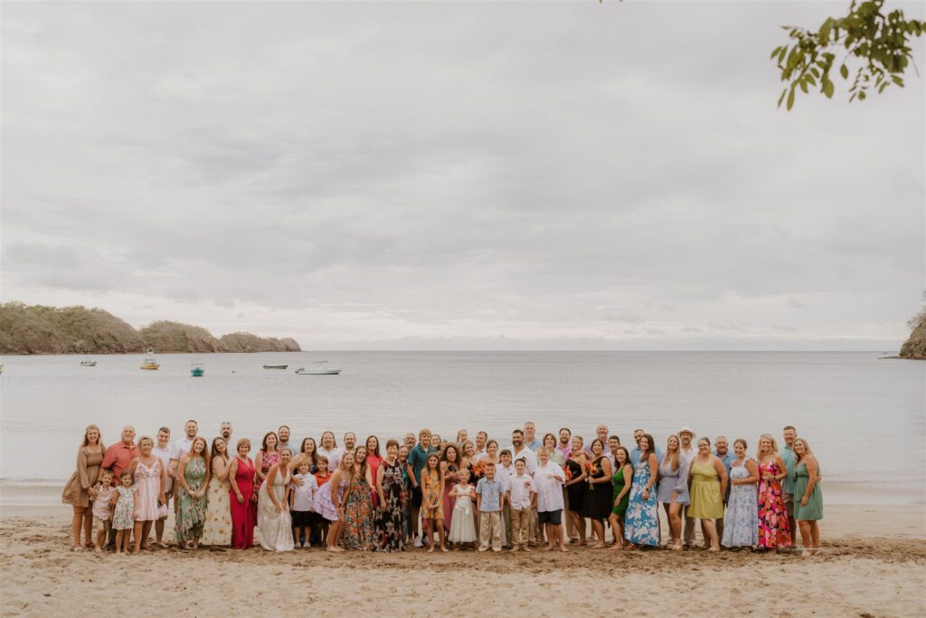 Real Destination Wedding Couple Jenn and Dan at Dreams Las Mareas Costa Rica bride and groom with guests on the beach