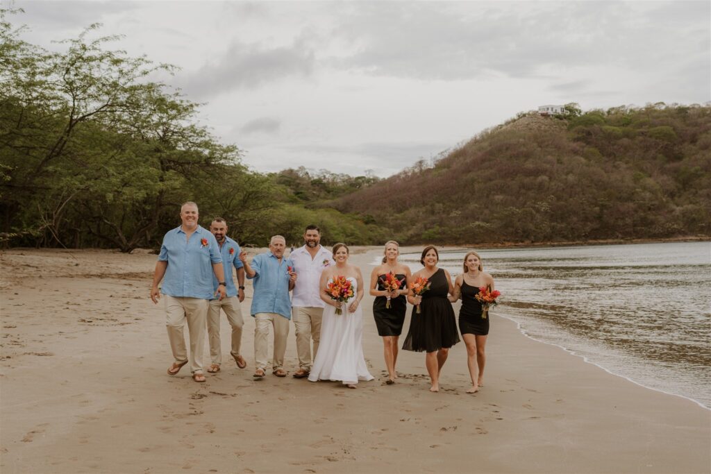 Real Destination Wedding Couple Jenn and Dan at Dreams Las Mareas Costa Rica bride and groom with wedding party on the beach