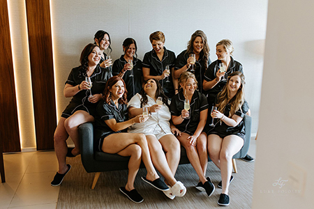 Bride and bridesmaids toast the wedding day in pajamas