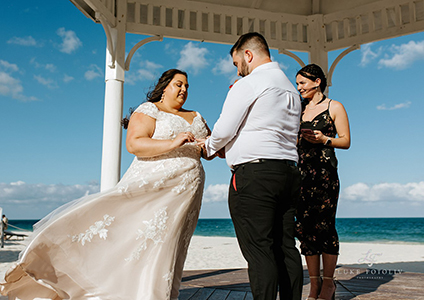 Couple getting married in a gazebo on a beach in Mexico