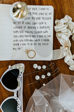 flat lay of wedding accessories and vows