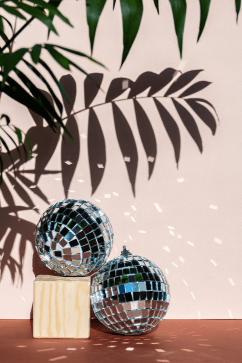 disco balls with shadows of palm trees as destination wedding decor