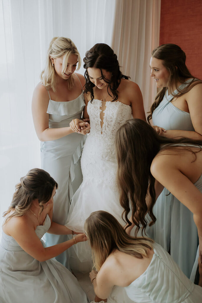 Lauren & Matthew's Destination Wedding at Dreams Vista Cancun | bridesmaids helping bride get ready