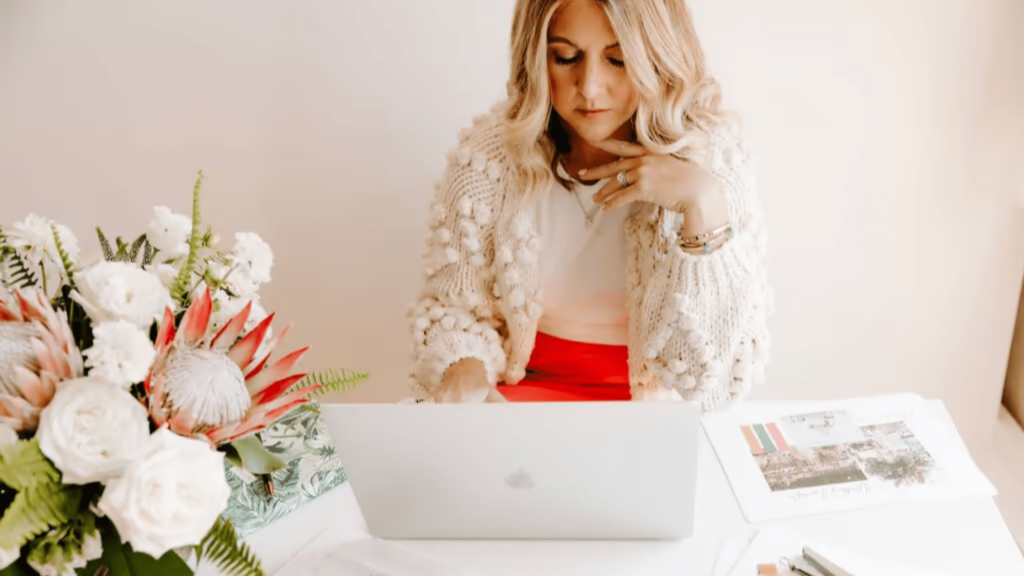 woman sitting at desk in front of a computer