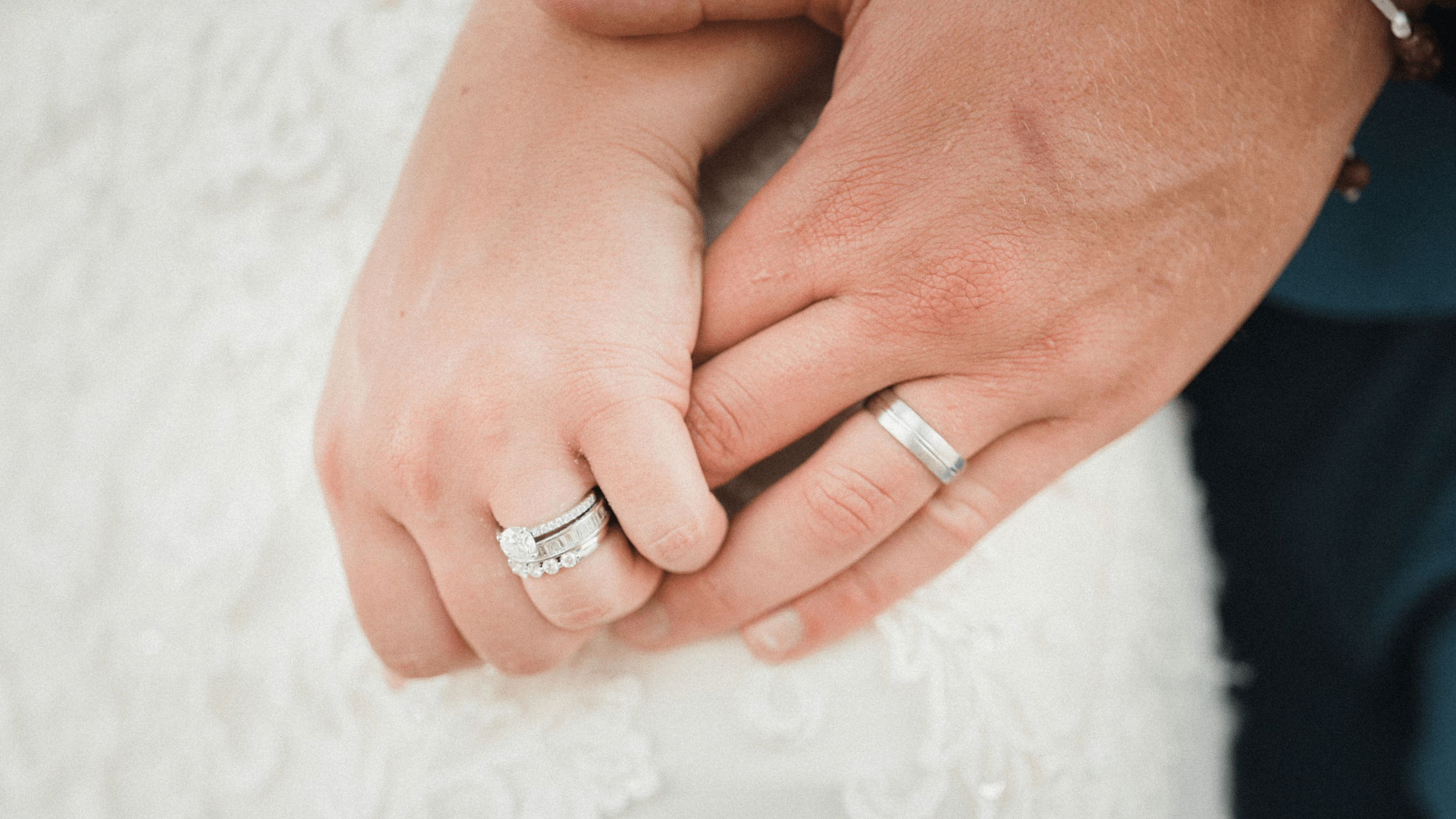 wedding couple holding hand showing wedding rings