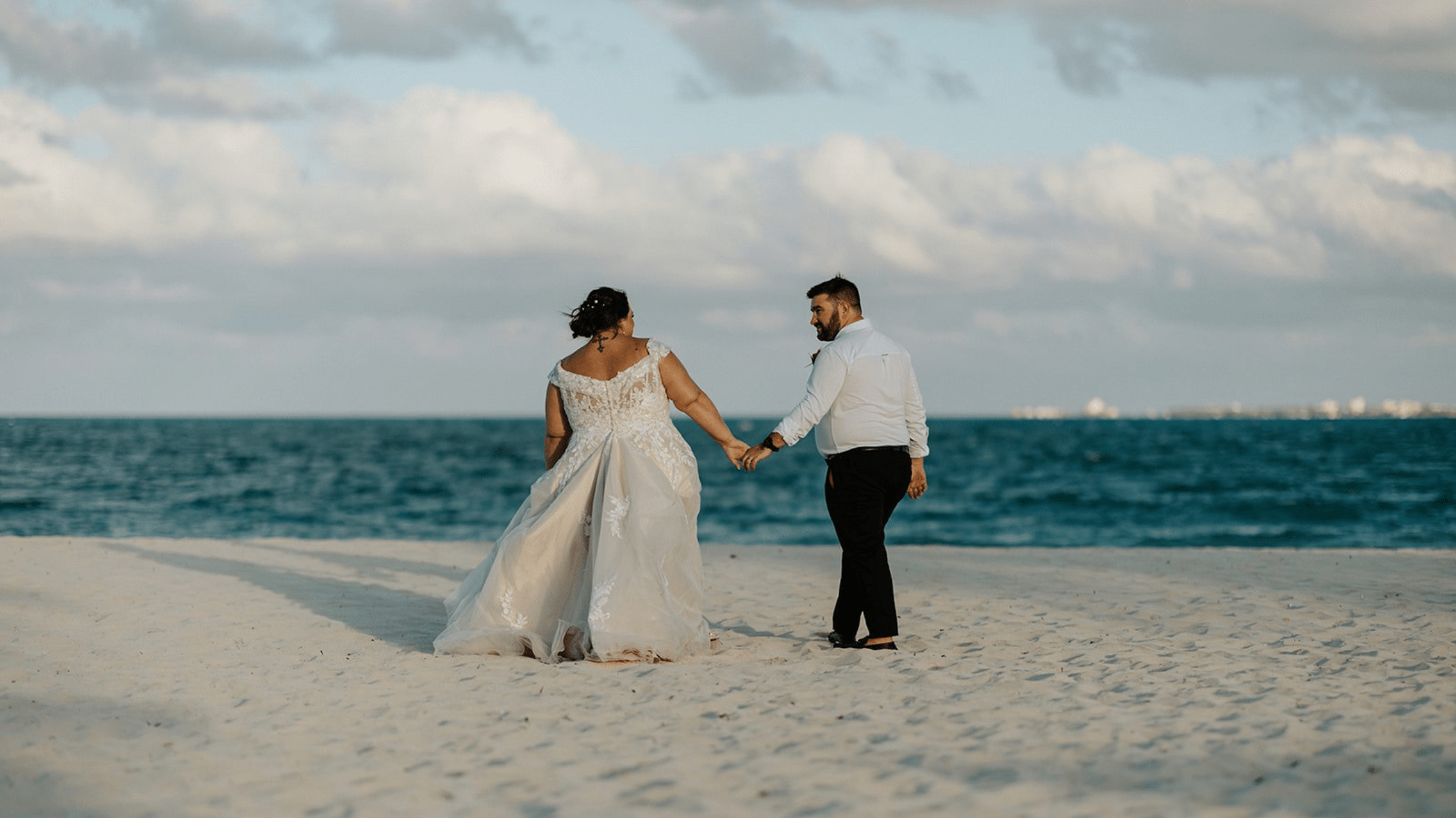 married couple walking on a beach in Mexico