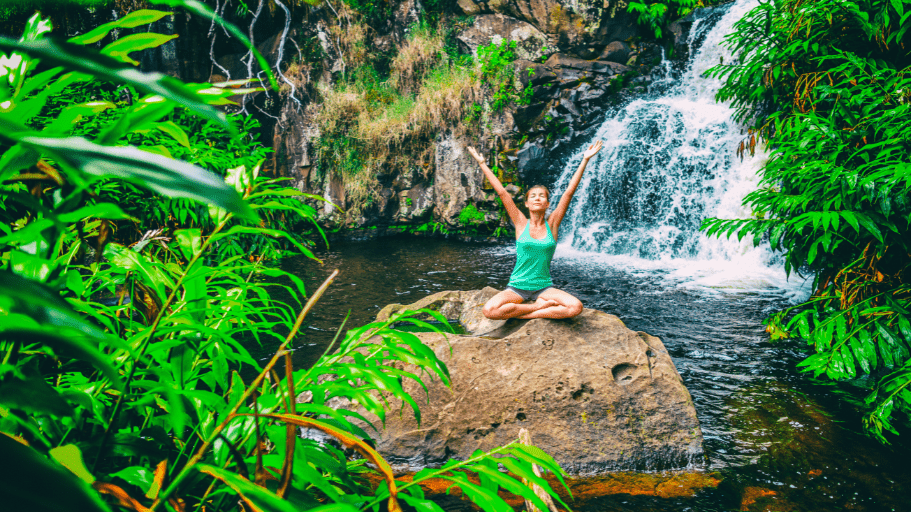 woman doing yoga on a rock in Costa Rican jungle