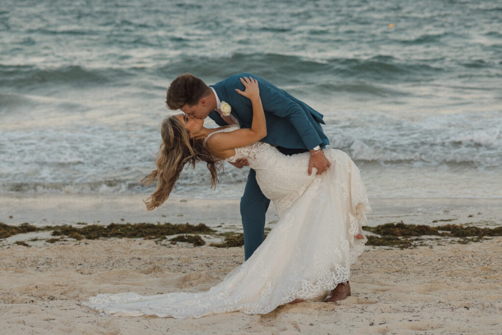 bride and groom kissing on the beach in mexico- how to get married in mexico
