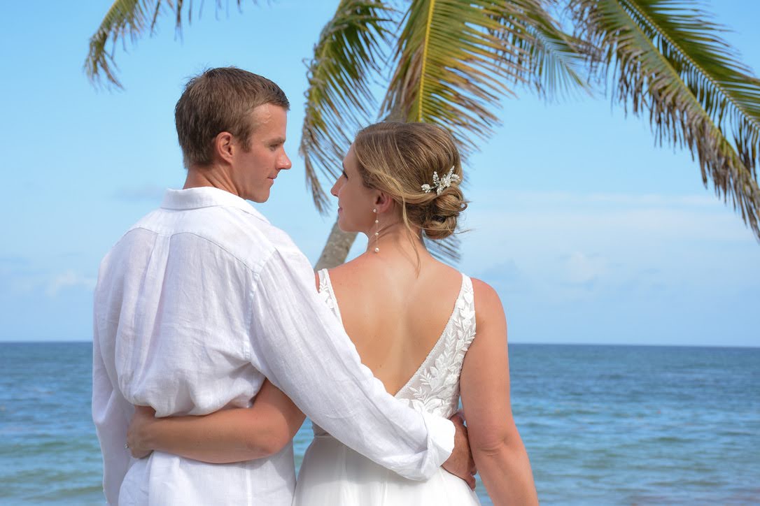 bride and groom look lovingly into each others eyes on the beach at the best destination wedding locations