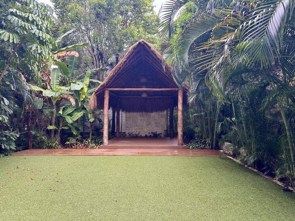 Lush garden ceremony location at Dreams Tulum designed for destination weddings not on the beach.