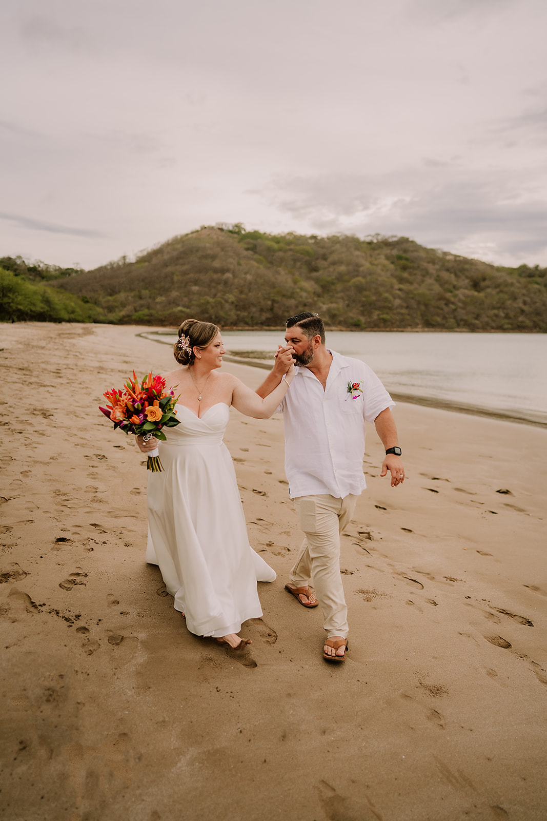 A bride and groom enjoy a quiet moment on the beach—showing what happens when destination wedding red flags are successfully avoided.