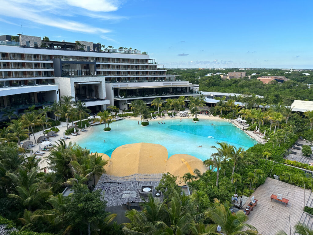 Expansive luxury resort with tropical lagoon-style pool, lush greenery, and balconies—among the best destination wedding resorts.