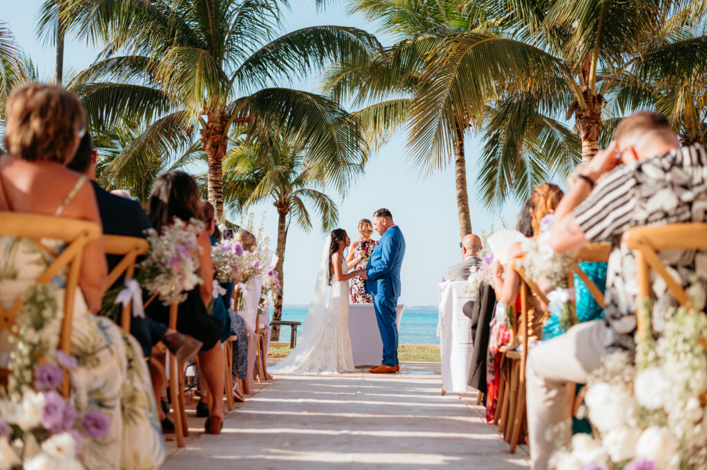destination wedding ceremony overlooking the ocean with palm trees