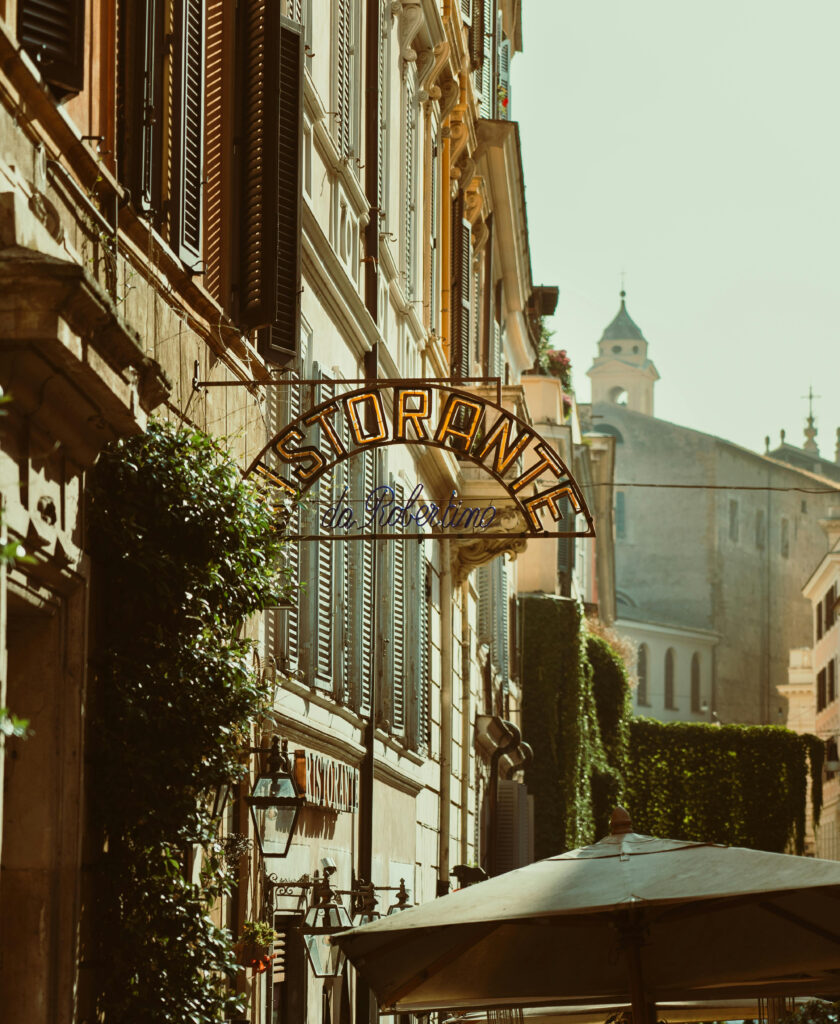 Charming Italian street with a ristorante sign, perfect for a cultural honeymoon itinerary stop.
