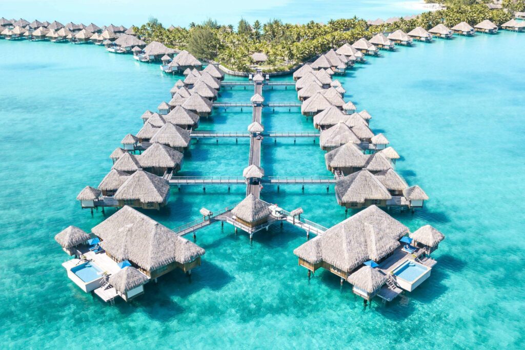 Luxury overwater villas lined across a turquoise lagoon, showcasing the elegance of top luxury honeymoon destinations.