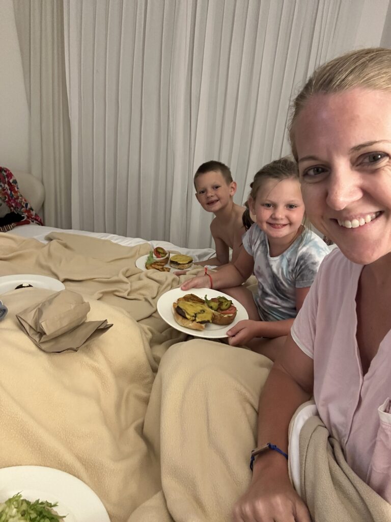 family enjoying room service on a family vacation to mexico 