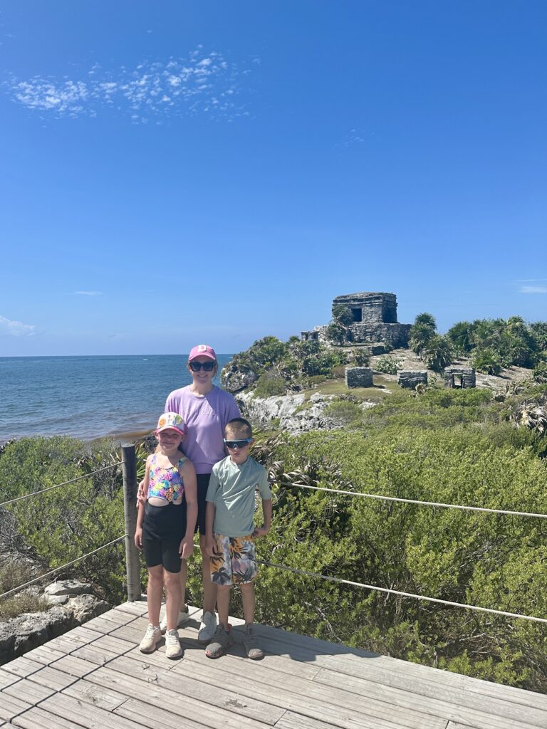 family at the Tulum ruins on a family vacation to mexico 