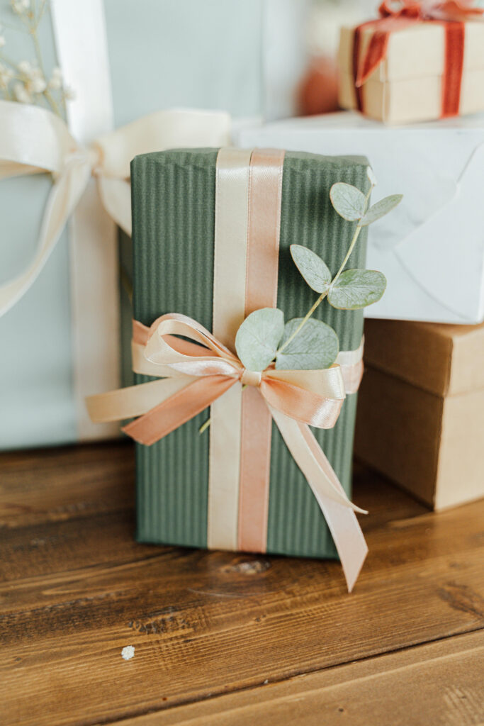 Sustainable wedding favor wrapped in green paper and ribbon, showcasing elegant eco friendly wedding ideas.