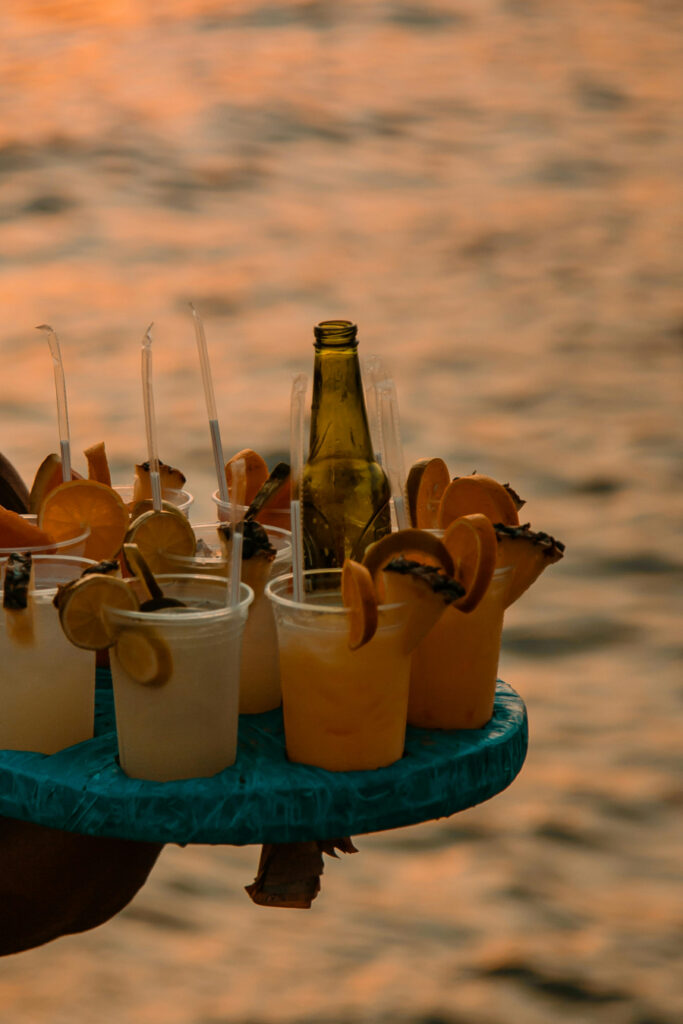 Tropical cocktails served at sunset on the beach—perfect for relaxed beachfront welcome events by the ocean.