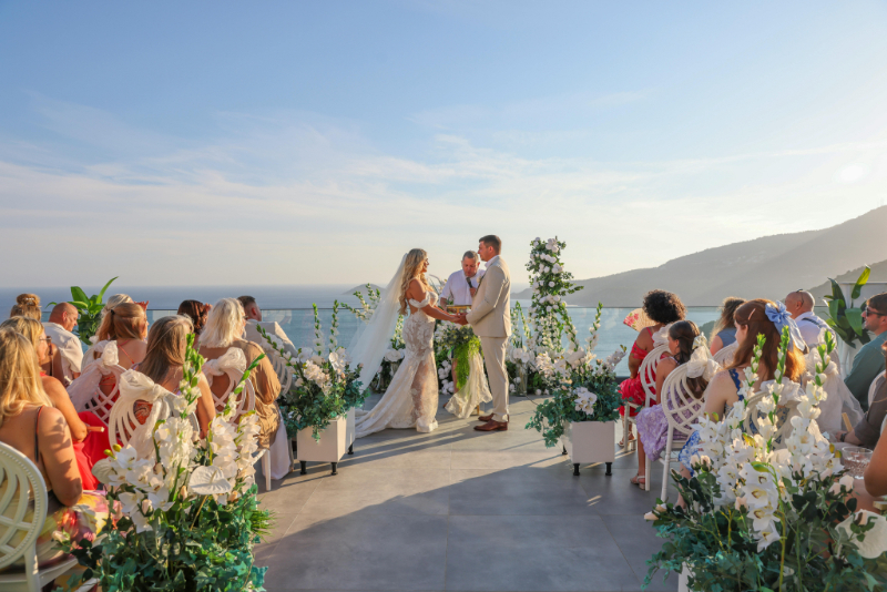 Outdoor Mexico ceremony with ocean view, showcasing a dreamy wedding guest experience guide in action.