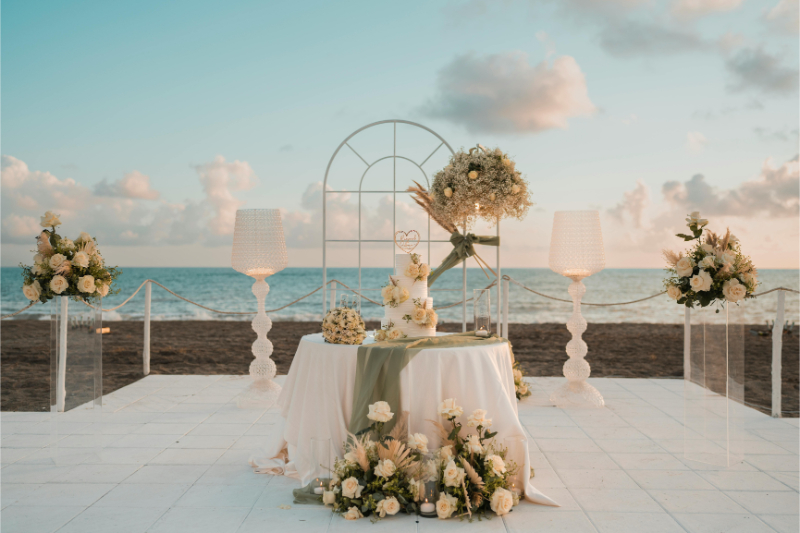 Elegant beach reception setup showing how much does a destination wedding cost at sunset.