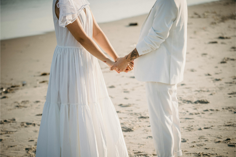 Romantic beach couple portrait reflecting how much does a destination wedding cost.