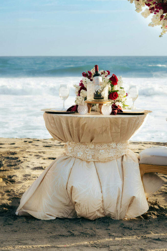 Elegant beach sweetheart table setup showing how much does a destination wedding cost.