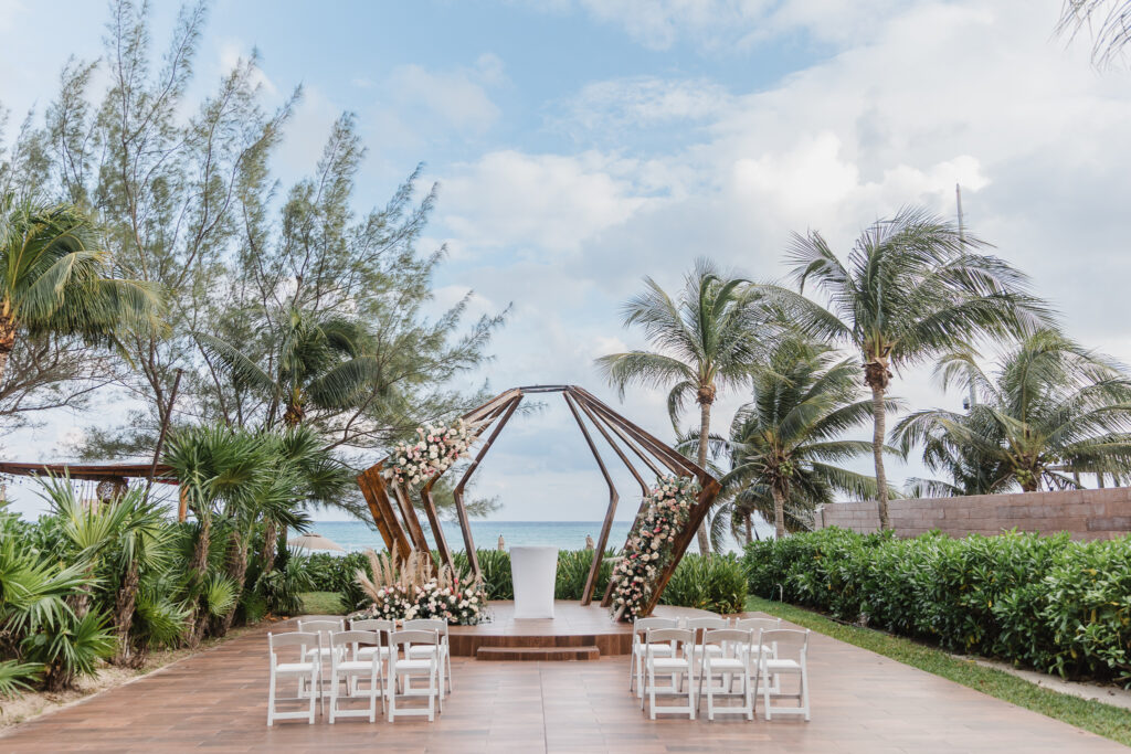 intimate Mexico destination wedding oceanfront ceremony setup at The Fives Beach Hotel