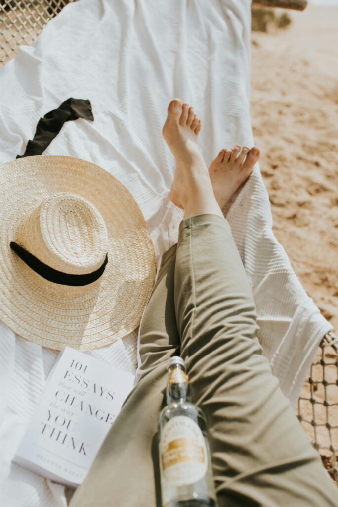 Relaxing beach moment with sun hat during peaceful honeymoon in Mexico getaway.