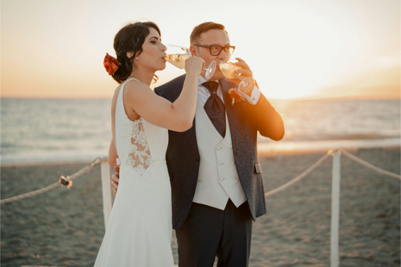 Bride and groom celebrating beach ceremony moment during destination wedding, inspiration for a wedding planning checklist.