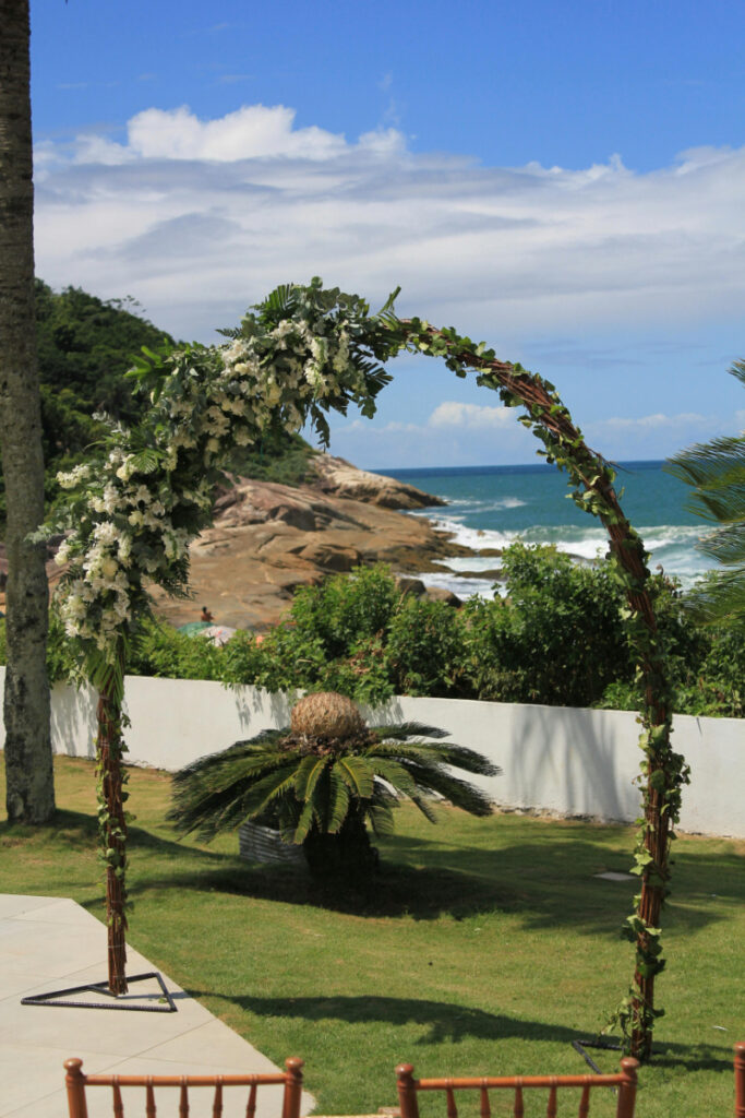 Tropical beach wedding arch with ocean view, destination ceremony inspiration for a wedding planning checklist.