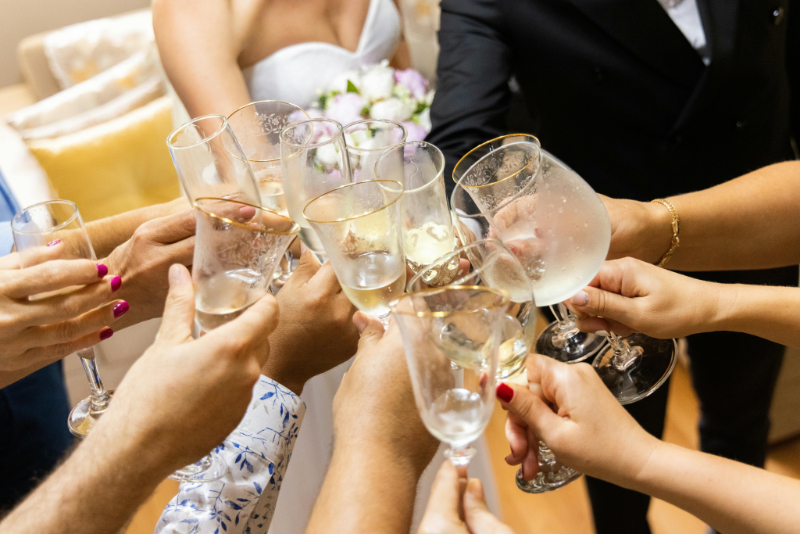 Wedding guests toasting with champagne glasses, celebrating together and creating the best wedding ever atmosphere