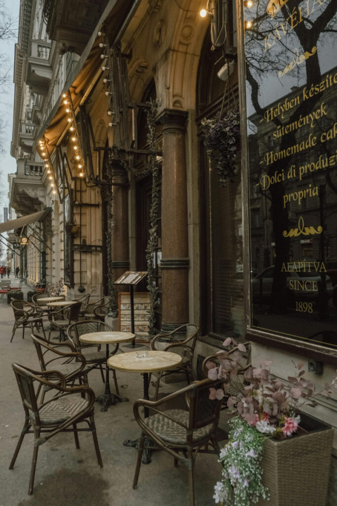 Romantic Europe trip with cozy street café, outdoor seating, and warm lights in historic city