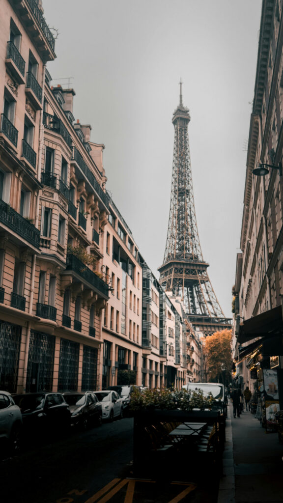 Romantic Europe trip with Eiffel Tower view along Paris street lined with classic buildings