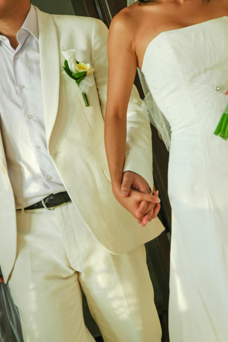 Destination wedding couple holding hands on beach, simple ceremony moment, wedding budget breakdown inspiration