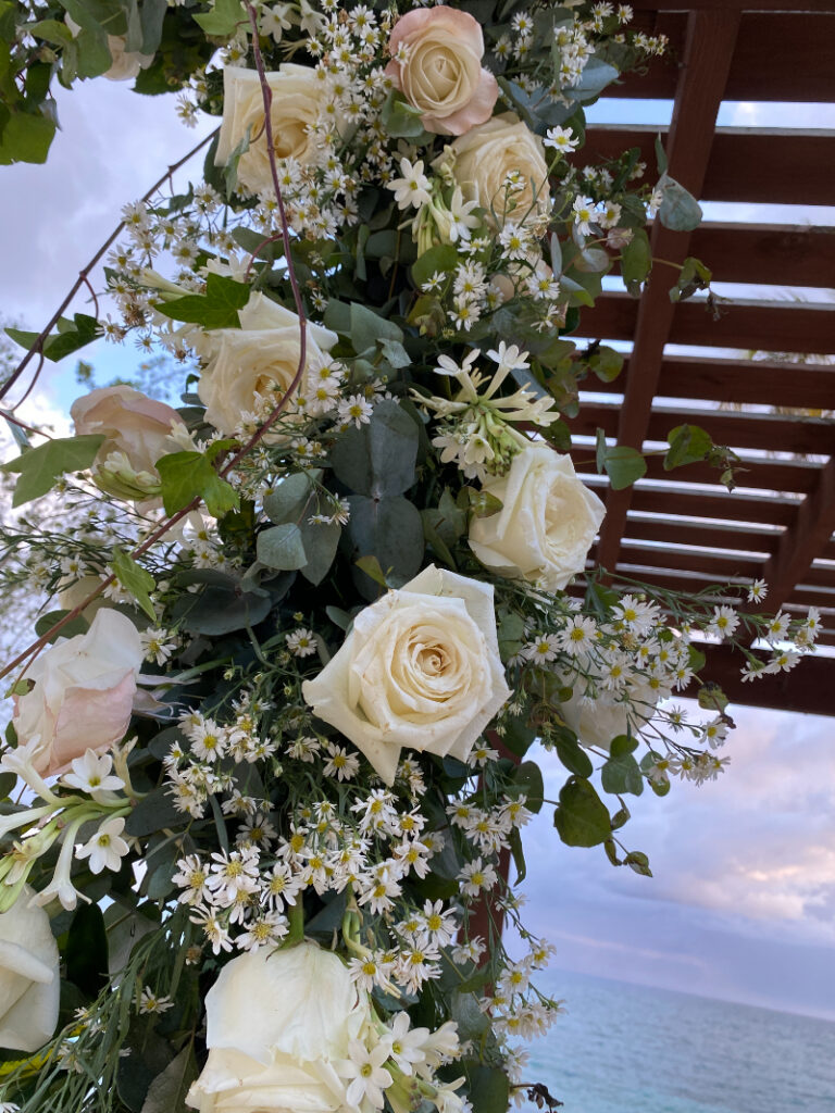 White rose wedding floral arrangement at a Dominican Republic destination wedding ceremony setup.