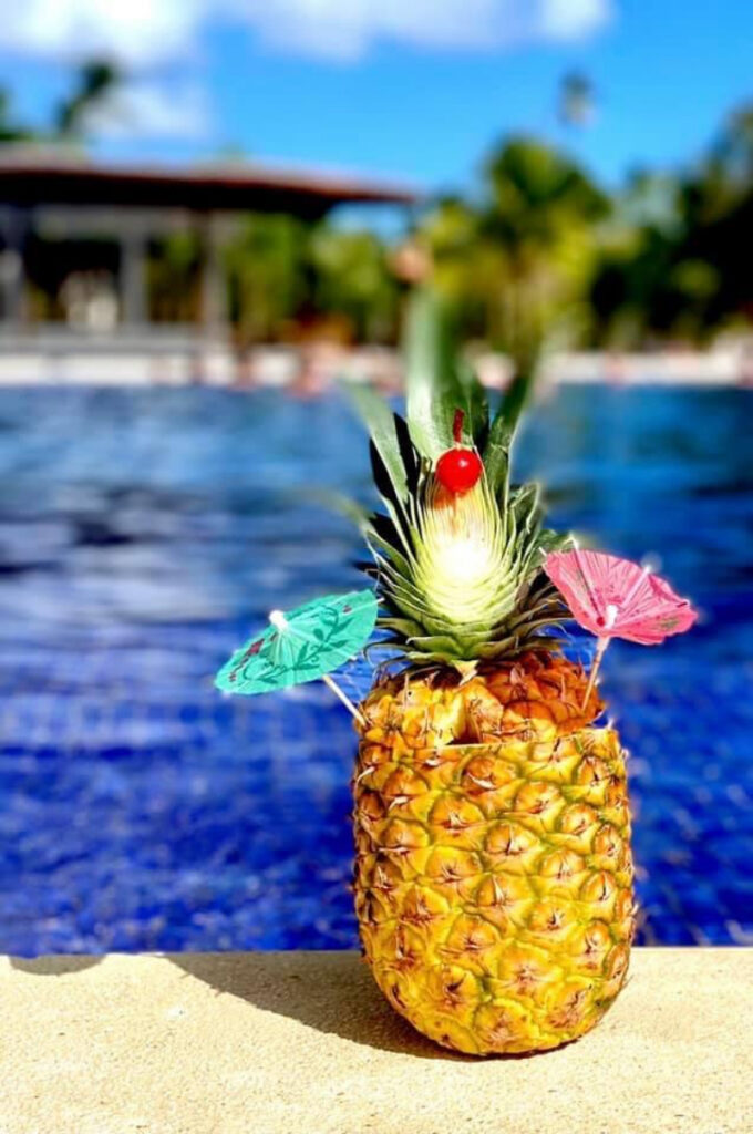 Tropical pineapple drink by the pool at a Dominican Republic destination wedding resort.