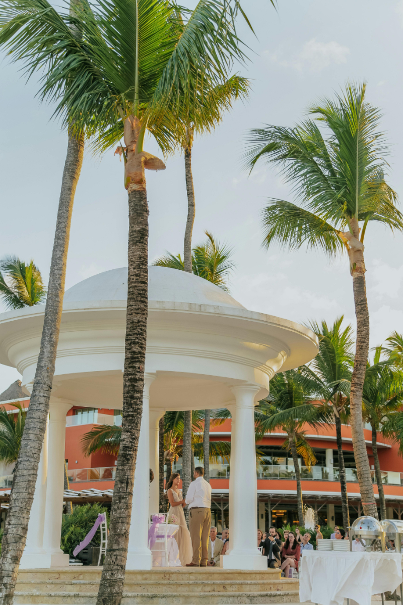 Luxury tropical resort entrance with palm trees, perfect place to book a destination wedding in Mexico