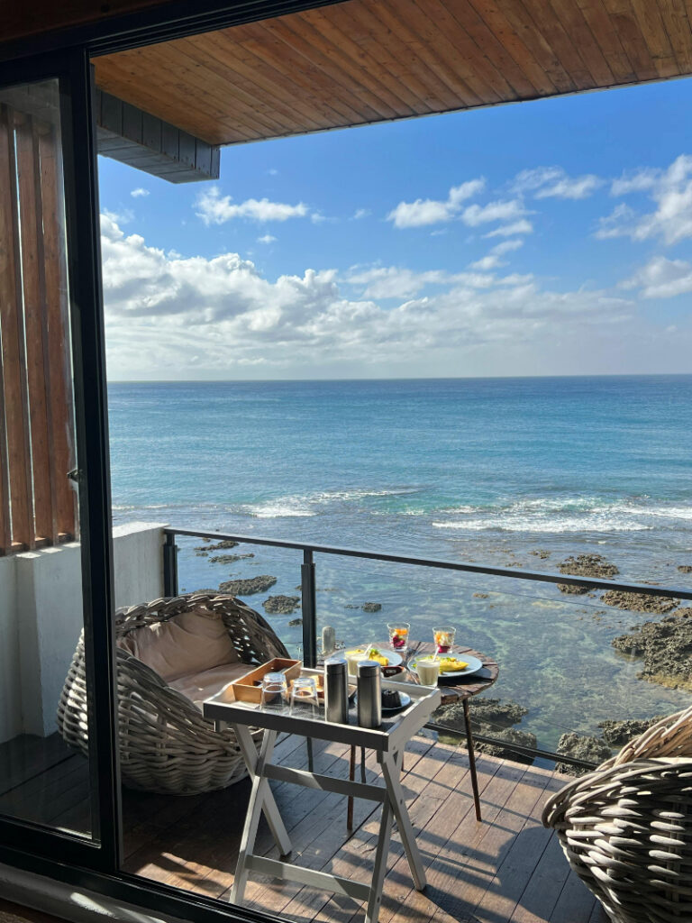 Oceanfront honeymoon balcony with breakfast setup showing why planning ahead helps book the best honeymoon views.