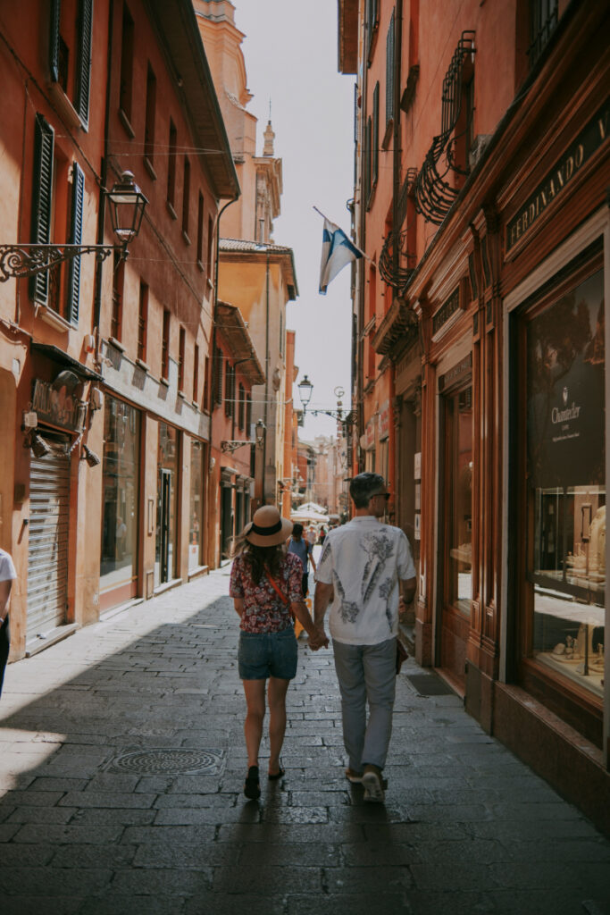 Couple walking through a European city highlights how destination choice affects average honeymoon cost.