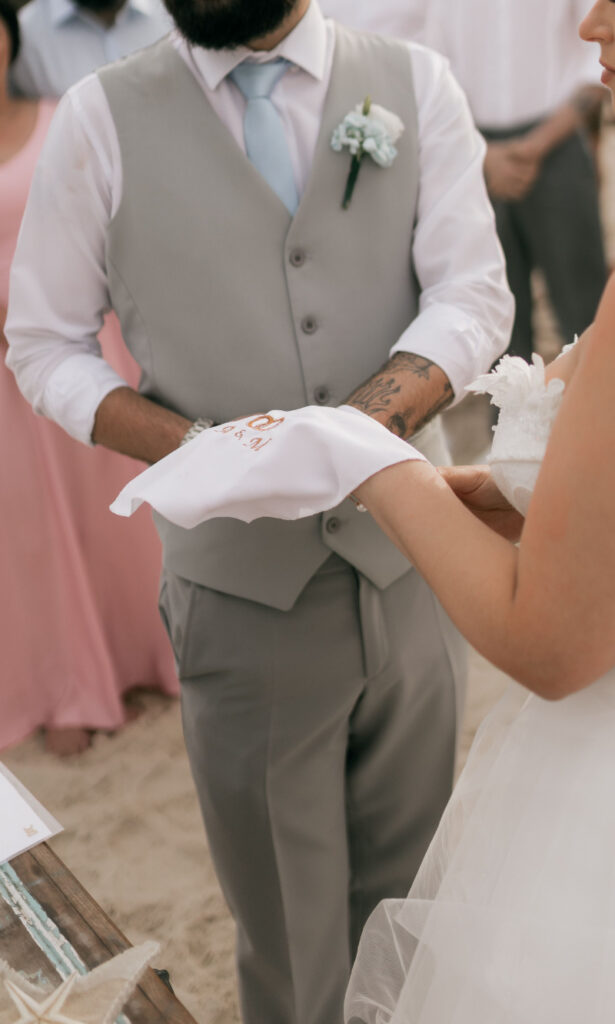 Cancun vs Riviera Maya beach wedding with couple participating in a symbolic unity ceremony
